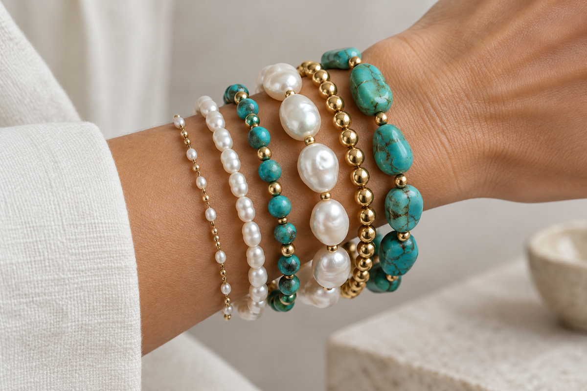Woman's wrist wearing stacked pearl and gemstone bracelets in different sizes — guide to choosing the right bracelet length and fit