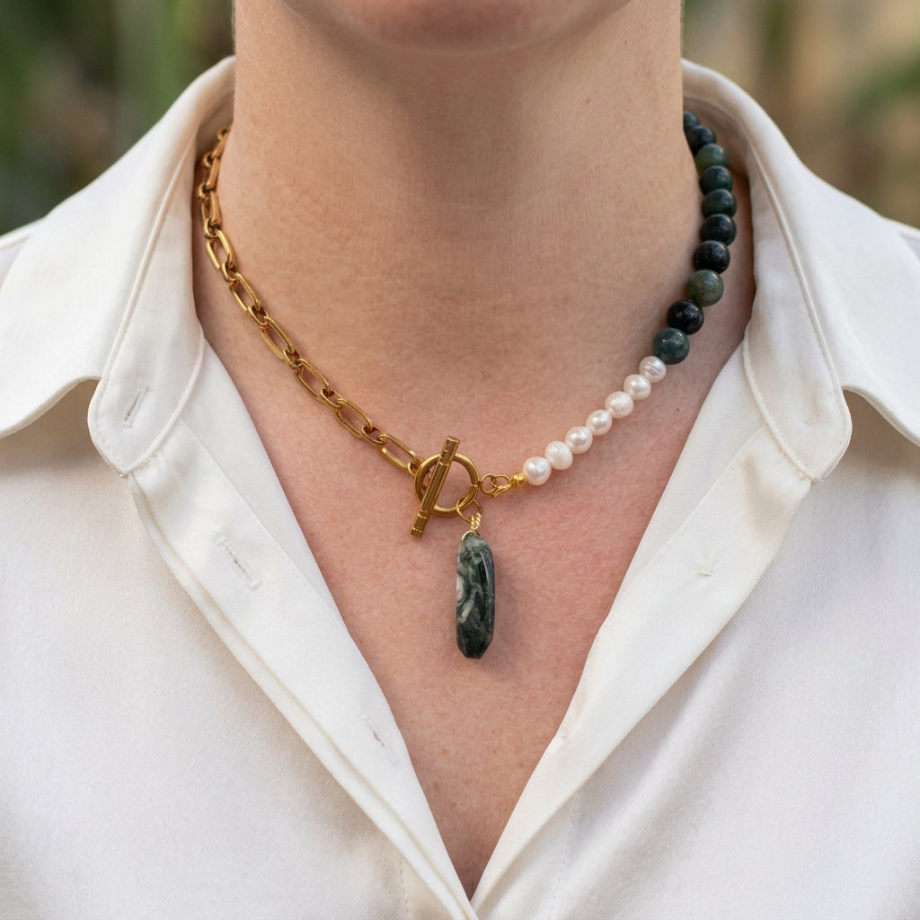 Green obsidian and white rice pearl necklace with a gold-plated paperclip chain, fastened front toggle and elongated green Indian agate pendant, worn with an open-neck white shirt.