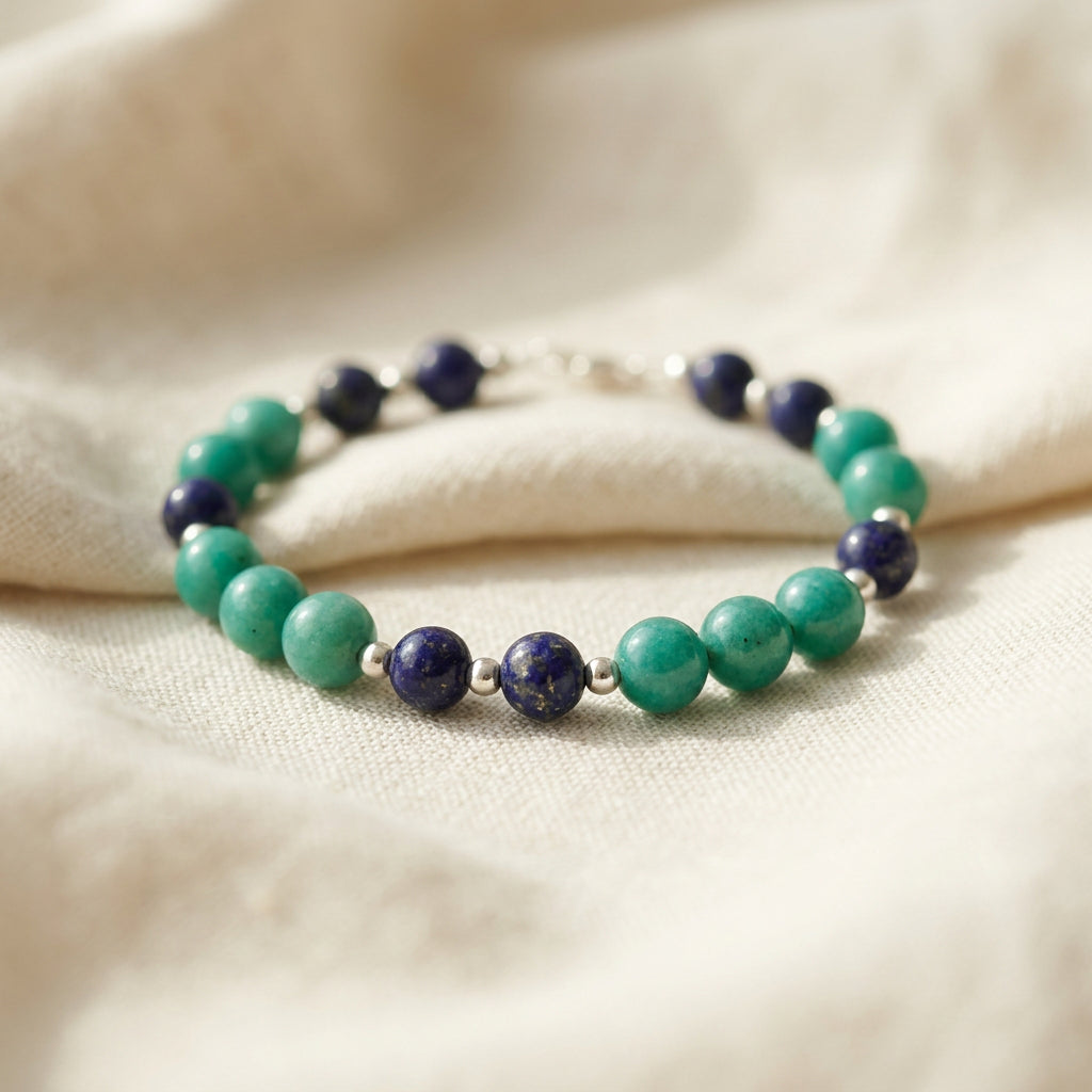 Lapis lazuli and Hubei turquoise bracelet on cream linen, showing groups of green-blue turquoise beads between dark blue lapis lazuli.
