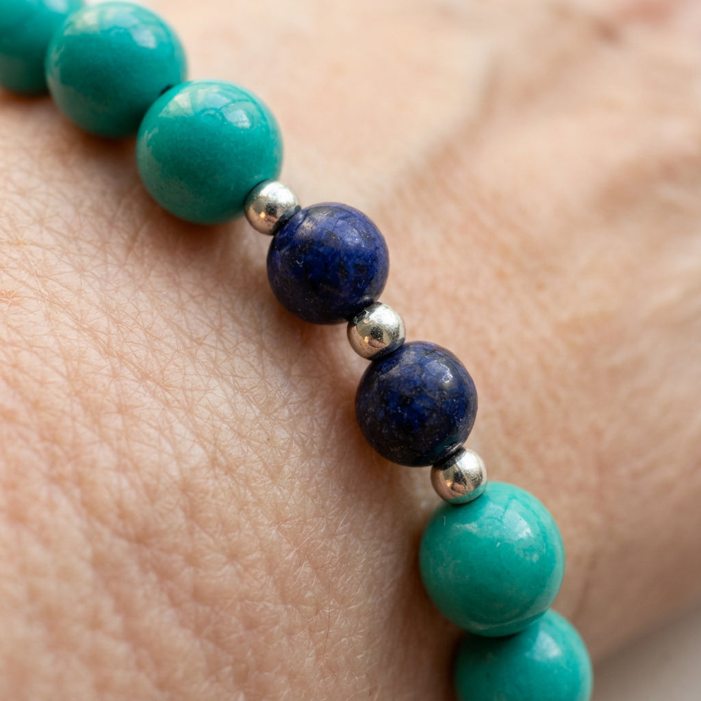 Macro view of three stabilised Hubei turquoise beads showing their colour variations and surface markings.