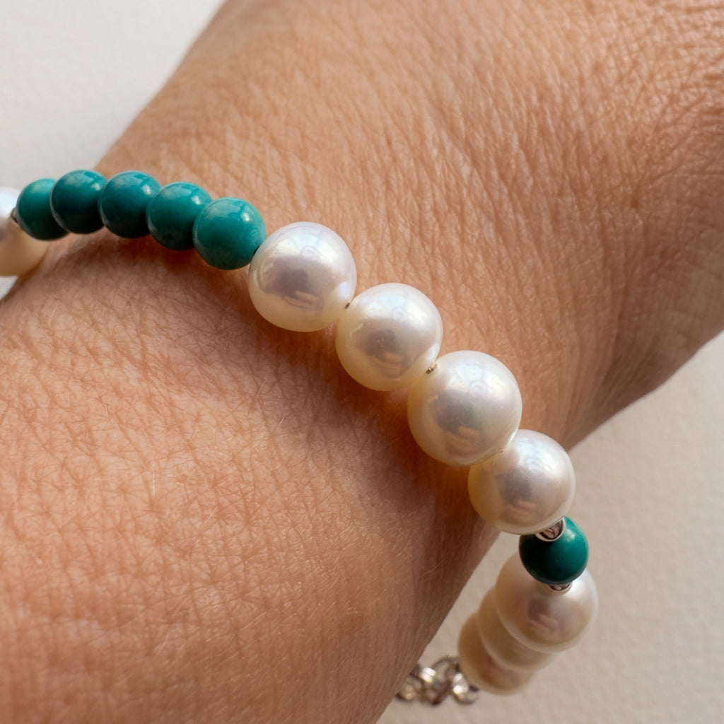 White baroque pearl and Hubei turquoise bracelet worn on the wrist, showing a group of pearls beside smaller turquoise beads.