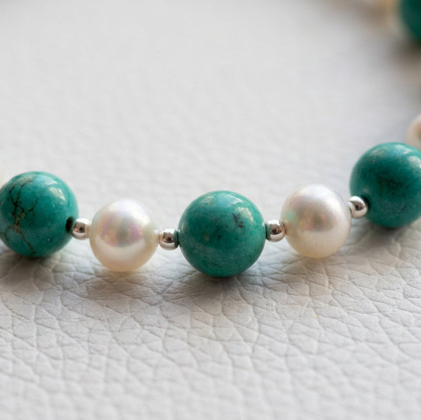 Close-up of Hubei turquoise markings and the lustre of white baroque pearls, separated by small sterling silver beads.