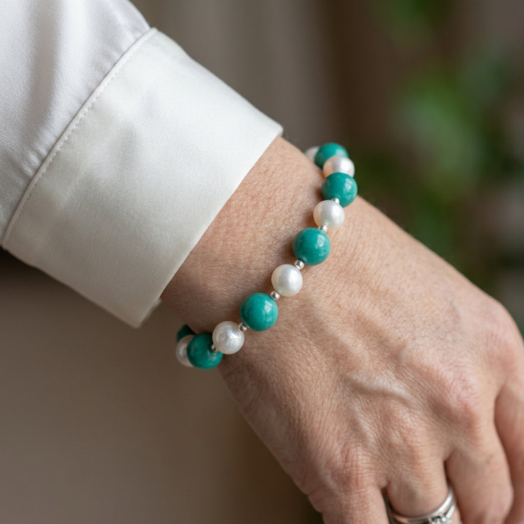 Side view of Hubei turquoise and white baroque pearl bracelet worn on the wrist, showing small sterling silver beads.
