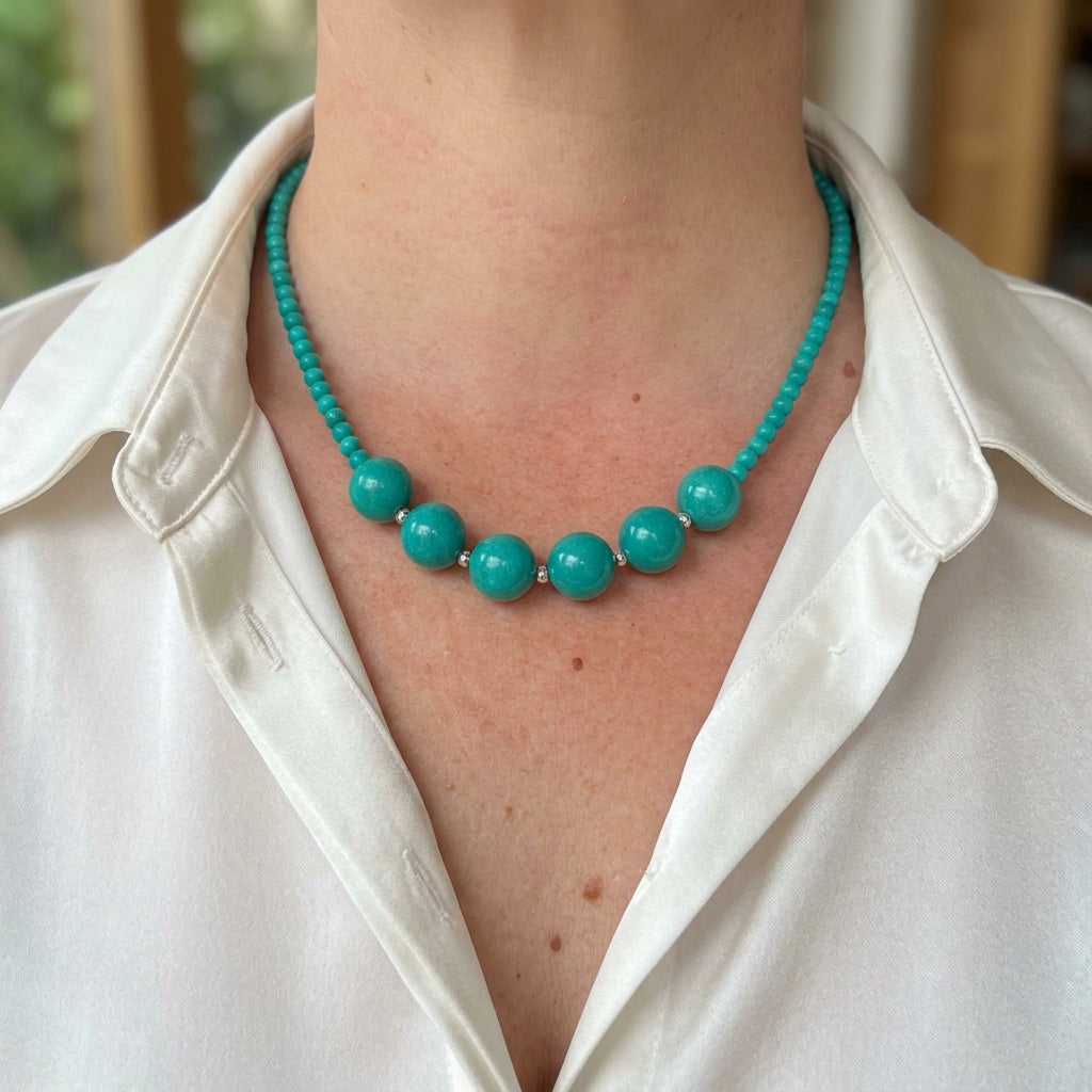Turquoise necklace worn with a white collared shirt, showing six larger Hubei turquoise beads at the centre and smaller beads along the sides.
